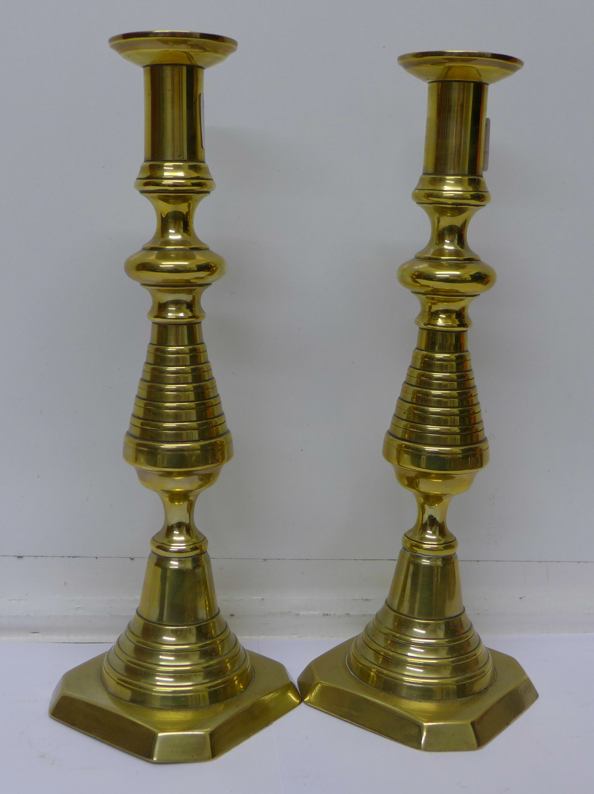 A pair of brass candlesticks,