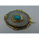 A yellow metal and turquoise brooch