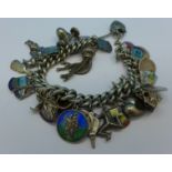 A silver charm bracelet with thirteen charms,