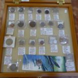 A display cabinet with twenty-three error coins,