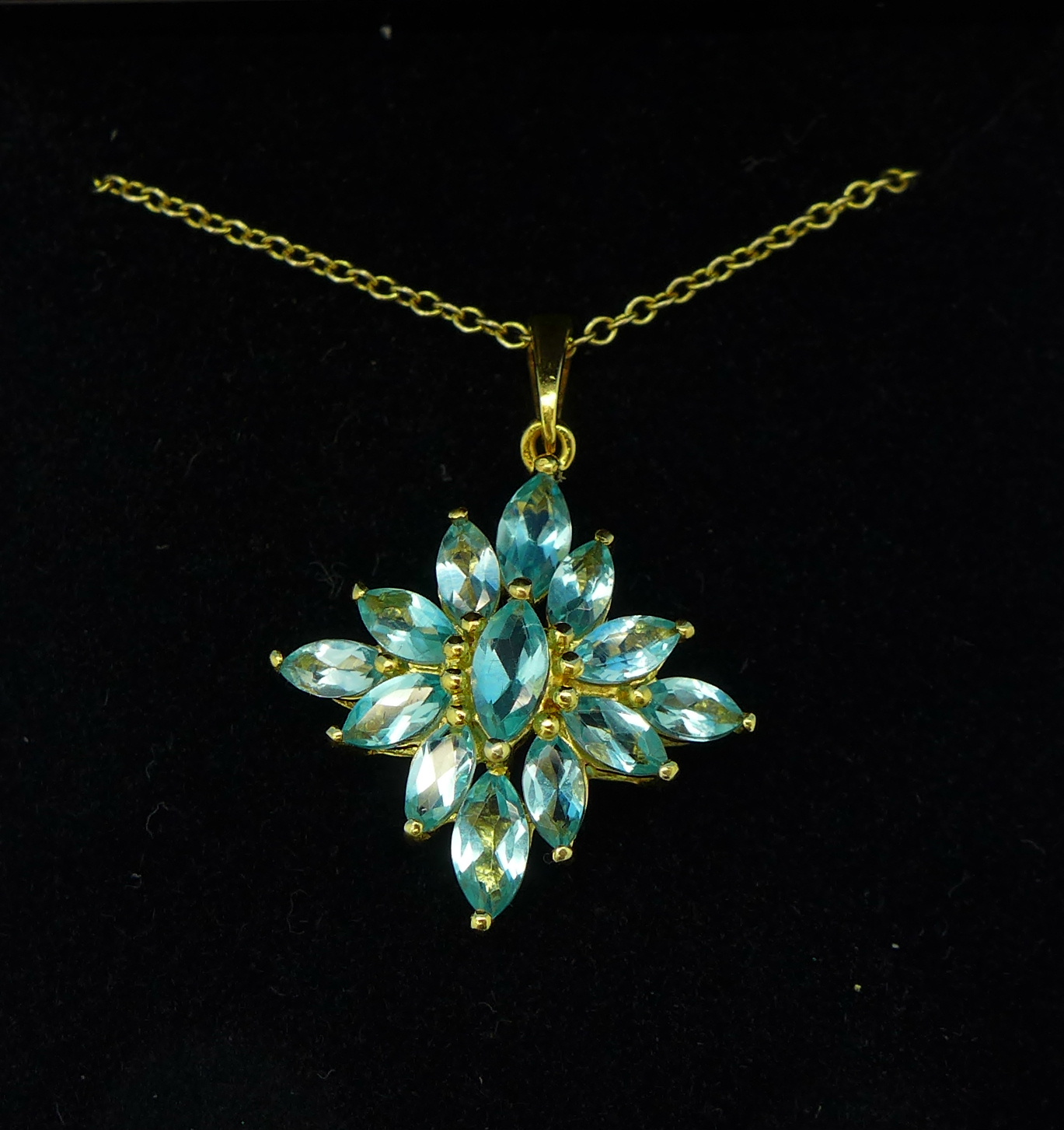 A silver gilt and apatite set pendant on chain