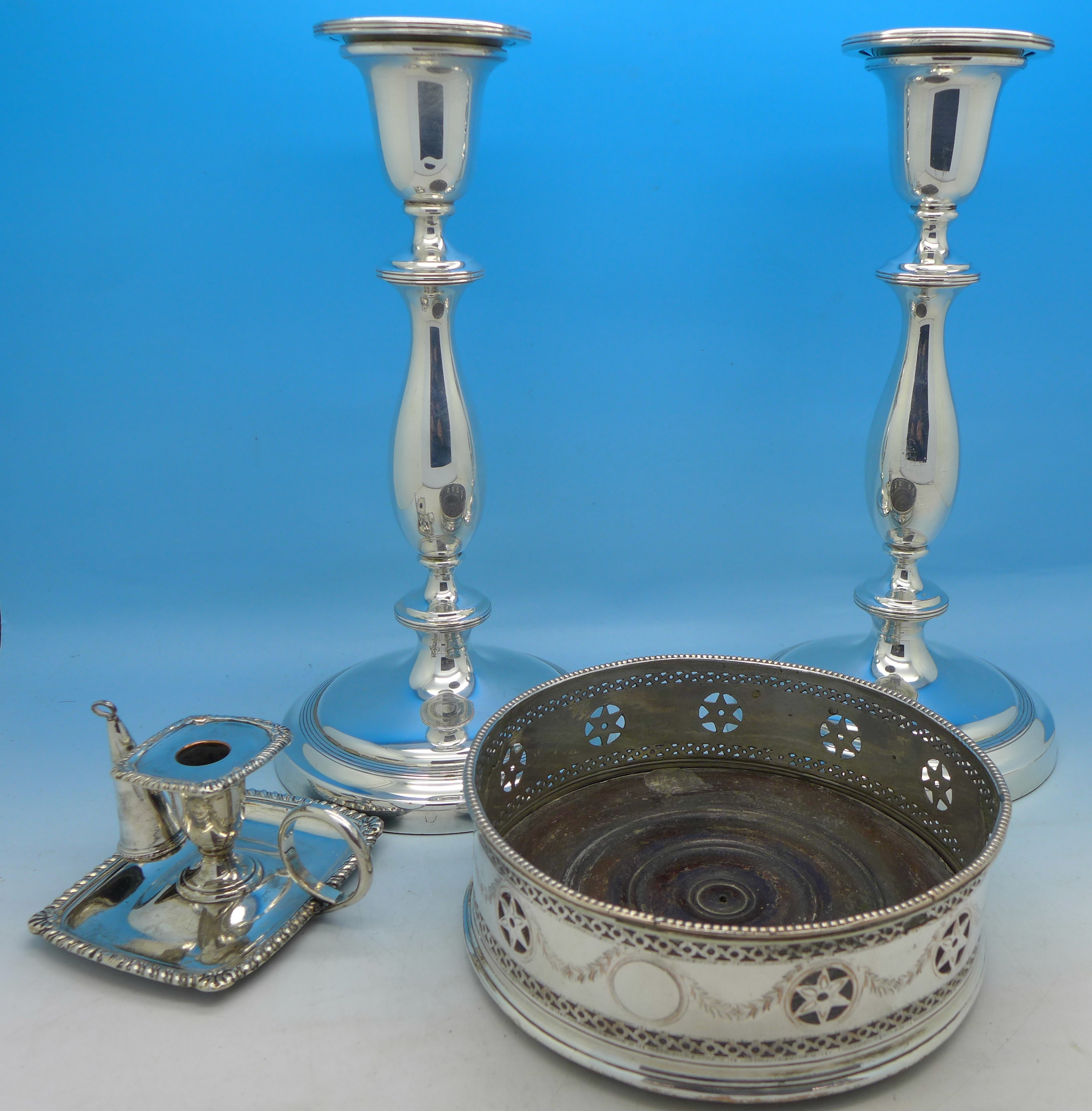 A pair of plated candlesticks,