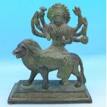 A bronze figure of a deity seated on a lion, a/f, 12.