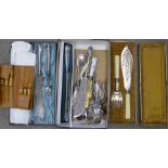 A Kings Pattern silver handled bread knife, fish servers, a carving set, plated sifters, etc.