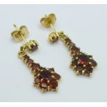 A pair of 9ct gold and garnet earrings, hallmarked on stem, replacement butterflies, 3.