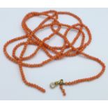 A long coral bead necklace with Albert clip,