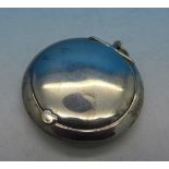 A silver compact pendant,