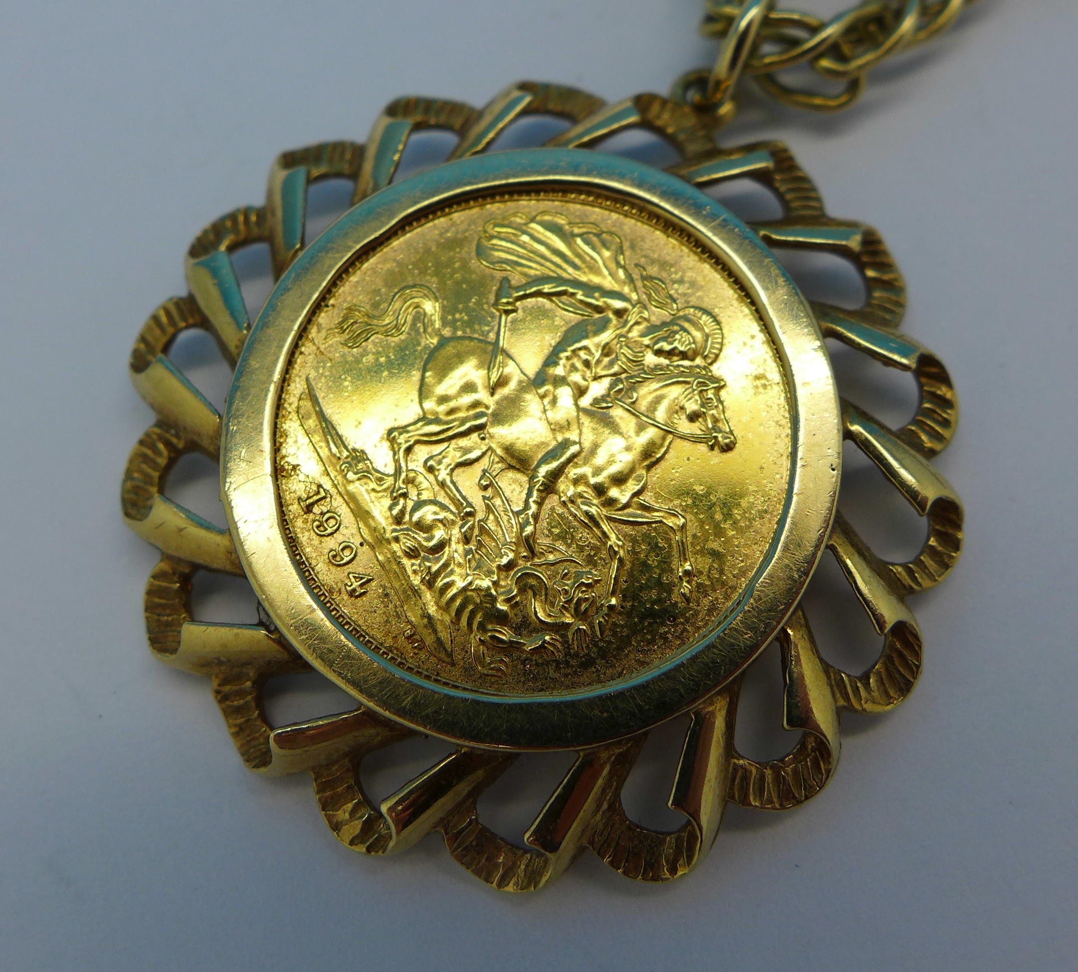 A 1994 full sovereign in a 9ct gold mount on a 9ct gold chain, chain a/f, 21. - Image 2 of 3