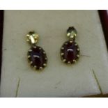 A pair of 9ct gold and cabochon garnet earrings