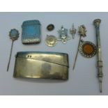 A Victorian silver vesta case, a silver card case, two Victorian pins, three silver fobs,