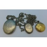 Two silver lockets with plated chains and a 9ct gold back and front locket,