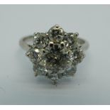 An 18ct gold, nine stone diamond cluster ring on white gold, Birmingham 1977,