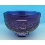 A signed Swedish art glass bowl in amethyst by Edenfalk for Skruf glass works decorated with the