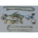 A silver charm bracelet, two chains, two rings and one cufflink,