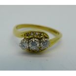 An 18ct gold and three stone diamond ring, 0.33ct diamond weight, 4.