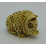 A carved ivory stylised rhinoceros netsuke, c.