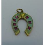 A yellow metal horseshoe pendant set with seven rubies, 1.