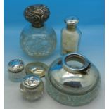 Four silver topped bottles and an inkwell,