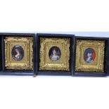 A set of three early 19th Century portrait miniatures of ladies, oval quarter length, on porcelain,