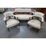 A Victorian mahogany and upholstered three piece salon suite