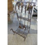 A cast metal fireside companion set and stand