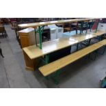 A German Bierkeller folding trestle table and a pair of benches