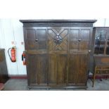 A Jacobean Revival fitted oak wardrobe