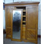 A Victorian Aesthetic Movement pine three door wardrobe