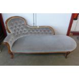 A Victorian style mahogany and upholstered chaise longue