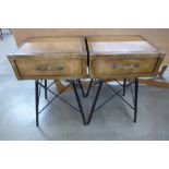 A pair of brown leather bedside tables on metal legs