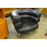 A chrome and faux black leather tub chair