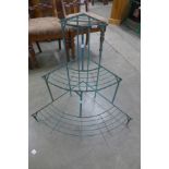 A wrought iron corner plant stand