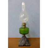 A Victorian cast iron based oil lamp