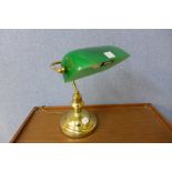 A student's brass desk lamp with green shade