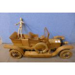 A wooden articulated artists lay figure and an oak and pine model of a vintage car