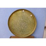 An Islamic brass circular plaque