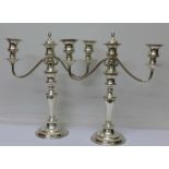 A pair of silver plate on copper candelabra/candlesticks