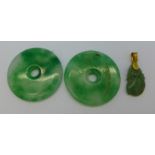 A 14ct gold and jade pendant and two jade disc pendants