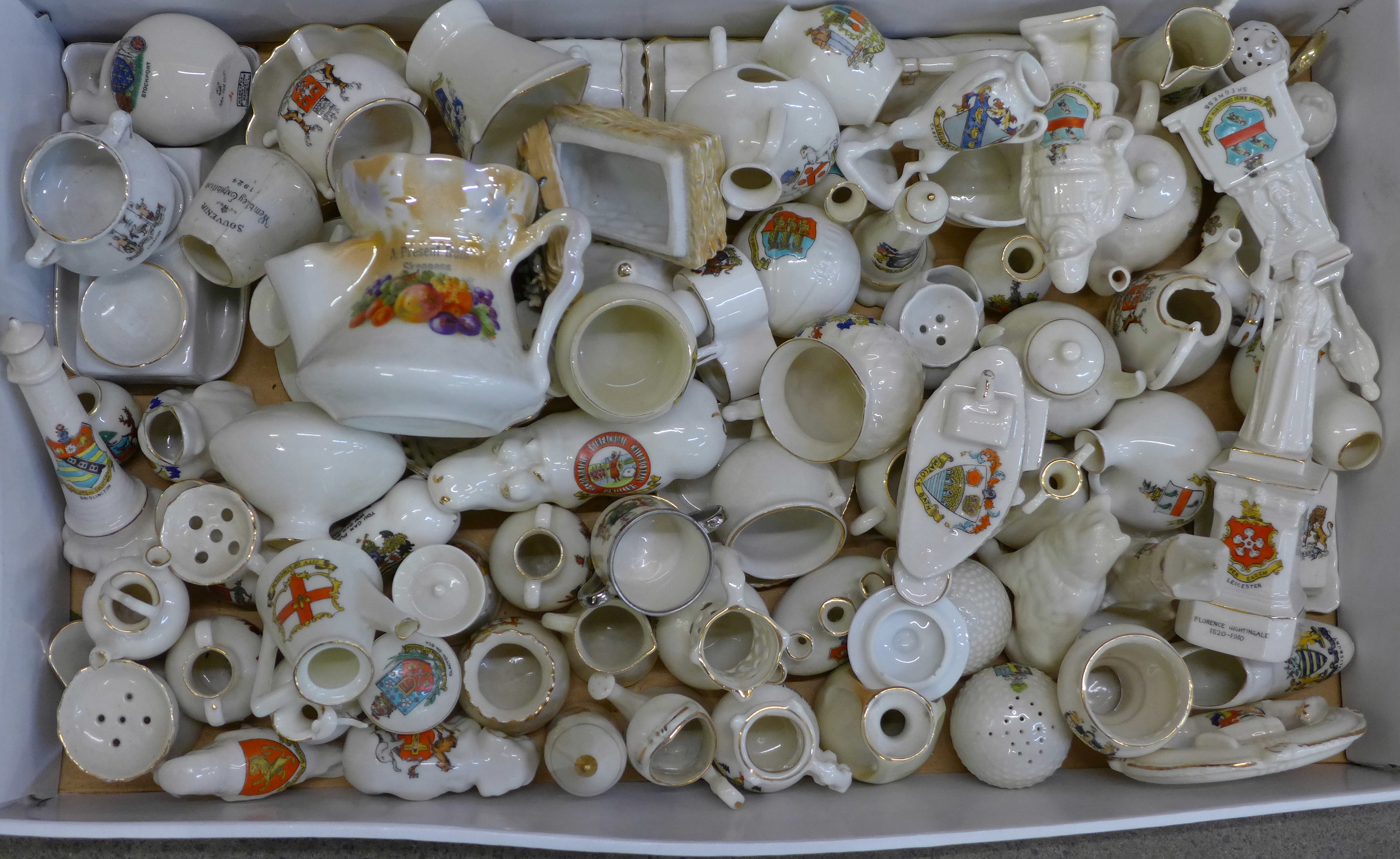 A large collection of crested china including WWI tank, football, golf balls, statues, etc.