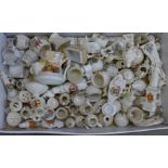 A large collection of crested china including WWI tank, football, golf balls, statues, etc.