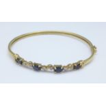 A 9ct gold, diamond and sapphire bangle, 4.