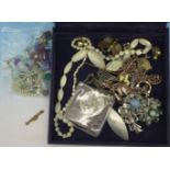 Costume jewellery including a graduated mother of pearl necklace and a 9ct gold brooch,