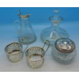 A silver topped glass oil jug, two silver coffee can holders,