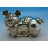 A white metal box in the form of a pig, stamped T90,