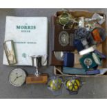 A collection of motoring trophies and medals, AA badges, Morris Minor workshop manual, car clock,