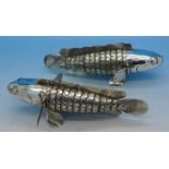 A pair of white metal articulated fish, 15.