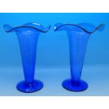 A pair of blue glass trumpet shaped vases,
