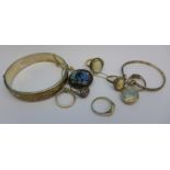 A silver bangle, a silver locket, a silver brooch lacking pin,