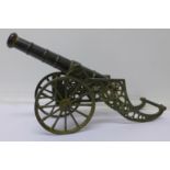 A bronzed model of a cannon,