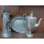 A pewter jug with blacksmith feature,